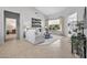 Bright and airy living room with neutral furniture, tile floors, and a view of the backyard at 15753 W Kino Dr, Surprise, AZ 85374