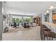 Open-concept living space with tile floors, ceiling fan, plenty of sunlight, and backyard views at 15753 W Kino Dr, Surprise, AZ 85374