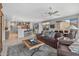 Spacious living room features ceiling fan, tile flooring, and open floorplan to dining and kitchen at 15753 W Kino Dr, Surprise, AZ 85374