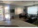 Open-concept living area with a comfortable sofa, dining set, and seamless indoor-outdoor flow at 15753 W Kino Dr, Surprise, AZ 85374