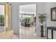 Open living space with tile floors, and view of living room with ceiling fan and outdoor patio at 15753 W Kino Dr, Surprise, AZ 85374