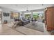 Cozy living room featuring a brown leather sofa and multiple windows at 15753 W Kino Dr, Surprise, AZ 85374