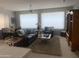 Spacious living room with a ceiling fan, a leather sofa set, and a view into the dining area at 15753 W Kino Dr, Surprise, AZ 85374