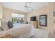 Relaxing main bedroom offering pool views, a ceiling fan, and carpet floors for a peaceful and private retreat at 15753 W Kino Dr, Surprise, AZ 85374