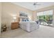 Serene main bedroom with a king bed and sliding glass doors opening to a pool, creating a relaxing retreat at 15753 W Kino Dr, Surprise, AZ 85374