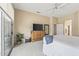 Bright main bedroom with sliding glass doors, ceiling fan, and ensuite bathroom access at 15753 W Kino Dr, Surprise, AZ 85374