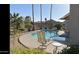 Relaxing backyard pool area featuring a spa, comfortable seating, and tropical plants at 15753 W Kino Dr, Surprise, AZ 85374