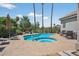 Relaxing backyard oasis with a sparkling pool, spa, desert landscaping, and clear blue skies at 15753 W Kino Dr, Surprise, AZ 85374