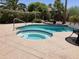 Inviting backyard pool and spa area surrounded by lush landscaping and patio space at 15753 W Kino Dr, Surprise, AZ 85374