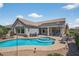 Gorgeous backyard pool and spa area with ample seating and covered patio, perfect for entertaining outdoors at 15753 W Kino Dr, Surprise, AZ 85374