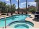 Inviting pool and spa surrounded by lush landscaping and a charming backyard setting at 15753 W Kino Dr, Surprise, AZ 85374