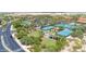 Aerial view of tennis courts, landscaping, and roads in a well-maintained and amenity-rich community at 15989 W Indianola Ave, Goodyear, AZ 85395