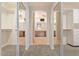 En-suite bath featuring dual sinks, walk-in closets, and tile flooring at 15989 W Indianola Ave, Goodyear, AZ 85395
