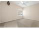 Bedroom with neutral carpet, shutters and a ceiling fan at 15989 W Indianola Ave, Goodyear, AZ 85395