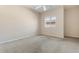 Bright bedroom features a ceiling fan and a window for natural light and a neutral color scheme at 15989 W Indianola Ave, Goodyear, AZ 85395