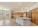 Bright kitchen with stainless steel appliances, center island, breakfast nook and light wood cabinetry at 15989 W Indianola Ave, Goodyear, AZ 85395