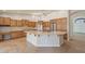 Spacious kitchen featuring an oversized center island, stainless steel appliances, and ample wood cabinets at 15989 W Indianola Ave, Goodyear, AZ 85395