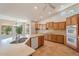 Bright kitchen showcasing stainless steel appliances, a center island, and light wood cabinets at 15989 W Indianola Ave, Goodyear, AZ 85395