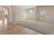 A spacious living room features neutral walls, large windows, carpet, and tiled entry, perfect for relaxing and entertaining at 15989 W Indianola Ave, Goodyear, AZ 85395