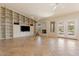 An open living room features built-in bookshelves, a fireplace, neutral tones, and ample natural light for entertaining at 15989 W Indianola Ave, Goodyear, AZ 85395