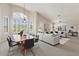 Bright, open concept living room with vaulted ceilings and an adjacent dining area is filled with natural light at 15989 W Indianola Ave, Goodyear, AZ 85395