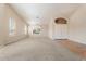 This cozy living room boasts neutral walls, large windows, carpet, and tiled entry, perfect for relaxing and Gathering gatherings at 15989 W Indianola Ave, Goodyear, AZ 85395