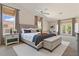 Comfortable main bedroom with a sitting area, bench and a large window at 15989 W Indianola Ave, Goodyear, AZ 85395