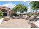 An inviting patio provides a cozy outdoor space perfect for relaxation, framed by mature landscaping, and desert charm at 15989 W Indianola Ave, Goodyear, AZ 85395
