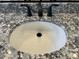 Close up of the granite counter, white sink, and black faucet in the bathroom at 16006 W Electra Ln, Surprise, AZ 85387