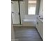 Elegant bathroom featuring a glass enclosed shower, a soaking tub, and wood-look tile flooring at 16006 W Electra Ln, Surprise, AZ 85387
