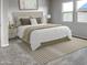 Cozy bedroom with a large bed, neutral tones, natural light, and carpet flooring at 16006 W Electra Ln, Surprise, AZ 85387