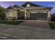 Beautiful single-Gathering home with a well-manicured lawn, brick driveway, and two car garage at 16006 W Electra Ln, Surprise, AZ 85387