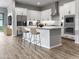 Modern kitchen with granite countertops, stainless steel appliances, and a large island with seating at 16006 W Electra Ln, Surprise, AZ 85387