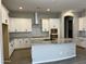 Well-lit kitchen featuring granite countertops, stainless steel hood vent, and custom cabinetry at 16006 W Electra Ln, Surprise, AZ 85387