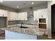 Spacious kitchen with granite countertops, stainless steel hood vent, and custom cabinetry at 16006 W Electra Ln, Surprise, AZ 85387