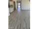 Spacious open-concept living area, featuring hardwood flooring, access to the kitchen, and natural light at 16006 W Electra Ln, Surprise, AZ 85387