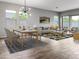 Bright living room featuring modern decor, wood-look tile flooring, and abundant natural light at 16006 W Electra Ln, Surprise, AZ 85387