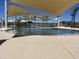 Community pool with play area, shade canopies, and plenty of open space at 16006 W Electra Ln, Surprise, AZ 85387