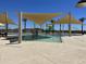Community splash pad with colorful play features and shaded lounge area at 16006 W Electra Ln, Surprise, AZ 85387