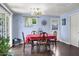 Cozy dining room with hardwood floors, stylish light fixture, and seating for six at 1639 W Indianola Ave, Phoenix, AZ 85015