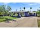 Blue single-story home with a spacious driveway and mature trees at 1639 W Indianola Ave, Phoenix, AZ 85015