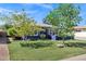 Landscaped front yard with mature trees and green grass at 1639 W Indianola Ave, Phoenix, AZ 85015