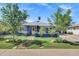 Charming blue home with a well-manicured front yard and inviting walkway at 1639 W Indianola Ave, Phoenix, AZ 85015