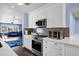 Bright kitchen featuring white cabinets, stainless steel appliances, modern countertops, and an open layout to living area at 1639 W Indianola Ave, Phoenix, AZ 85015