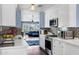 Well-lit kitchen with white cabinetry, stainless steel appliances, quartz countertops, and a view into the living space at 1639 W Indianola Ave, Phoenix, AZ 85015