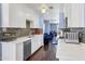 Modern kitchen with white cabinetry, stainless steel appliances, quartz countertops, and a stylish backsplash at 1639 W Indianola Ave, Phoenix, AZ 85015