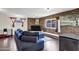 Inviting living room featuring a brick accent wall, plush blue sofa, and modern decor at 1639 W Indianola Ave, Phoenix, AZ 85015