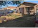 Backyard features a covered patio, grassy area, a swing, and gravel creating a relaxing outdoor retreat at 17328 W Pinnacle Vista Dr Dr, Surprise, AZ 85387