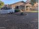 Spacious backyard featuring a rock garden, fire pit, and a covered patio ideal for outdoor entertaining at 17328 W Pinnacle Vista Dr Dr, Surprise, AZ 85387