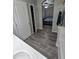 Bathroom with wood-look vinyl flooring, leading to a bedroom, showcasing ample storage at 17328 W Pinnacle Vista Dr Dr, Surprise, AZ 85387